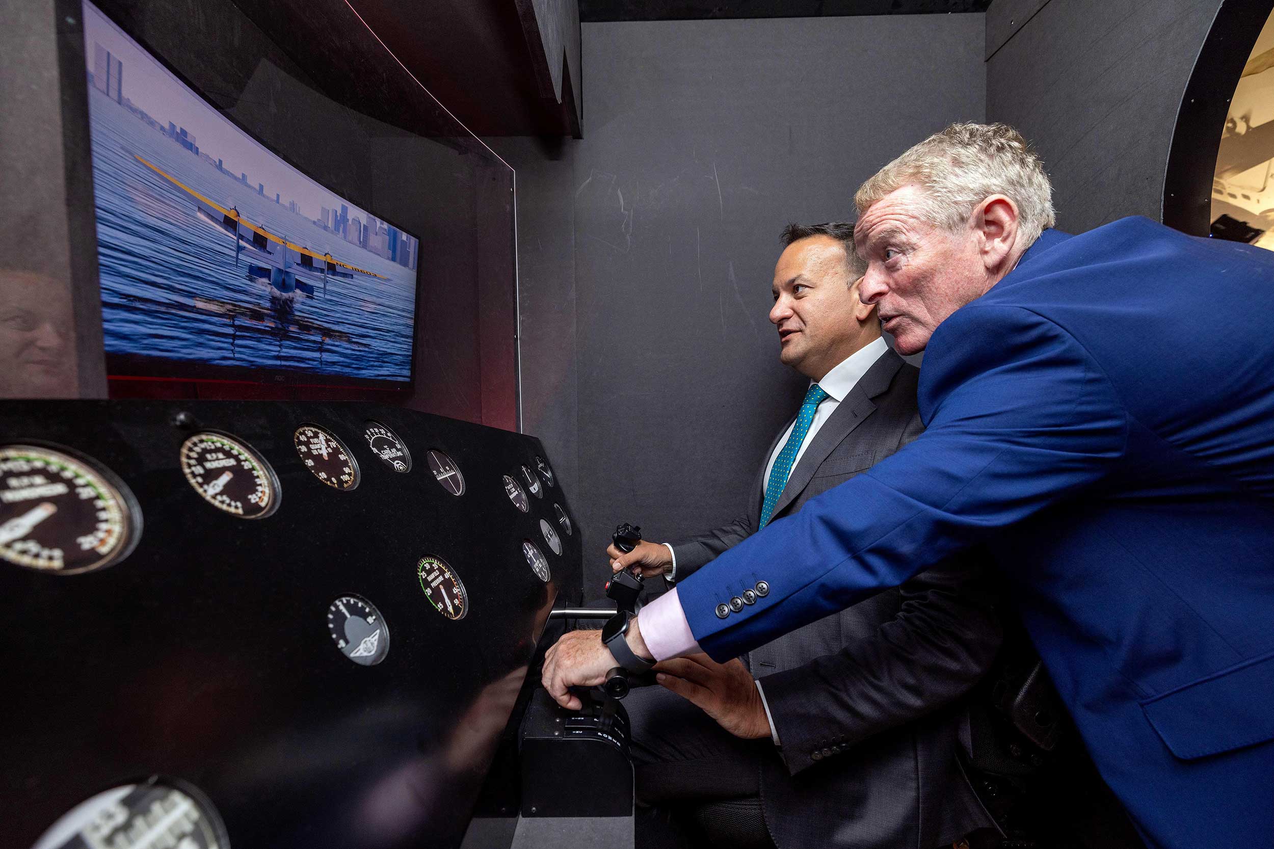 Taoiseach tries the flying boat simulator with museum chair Eamonn Brennan
