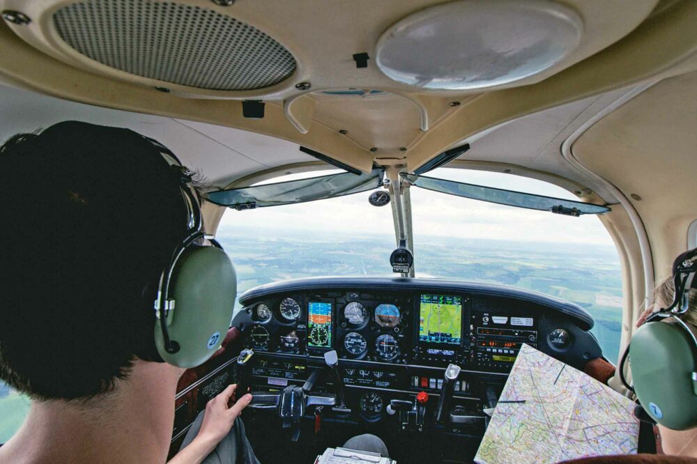 pilots in cockpit of light aircraft