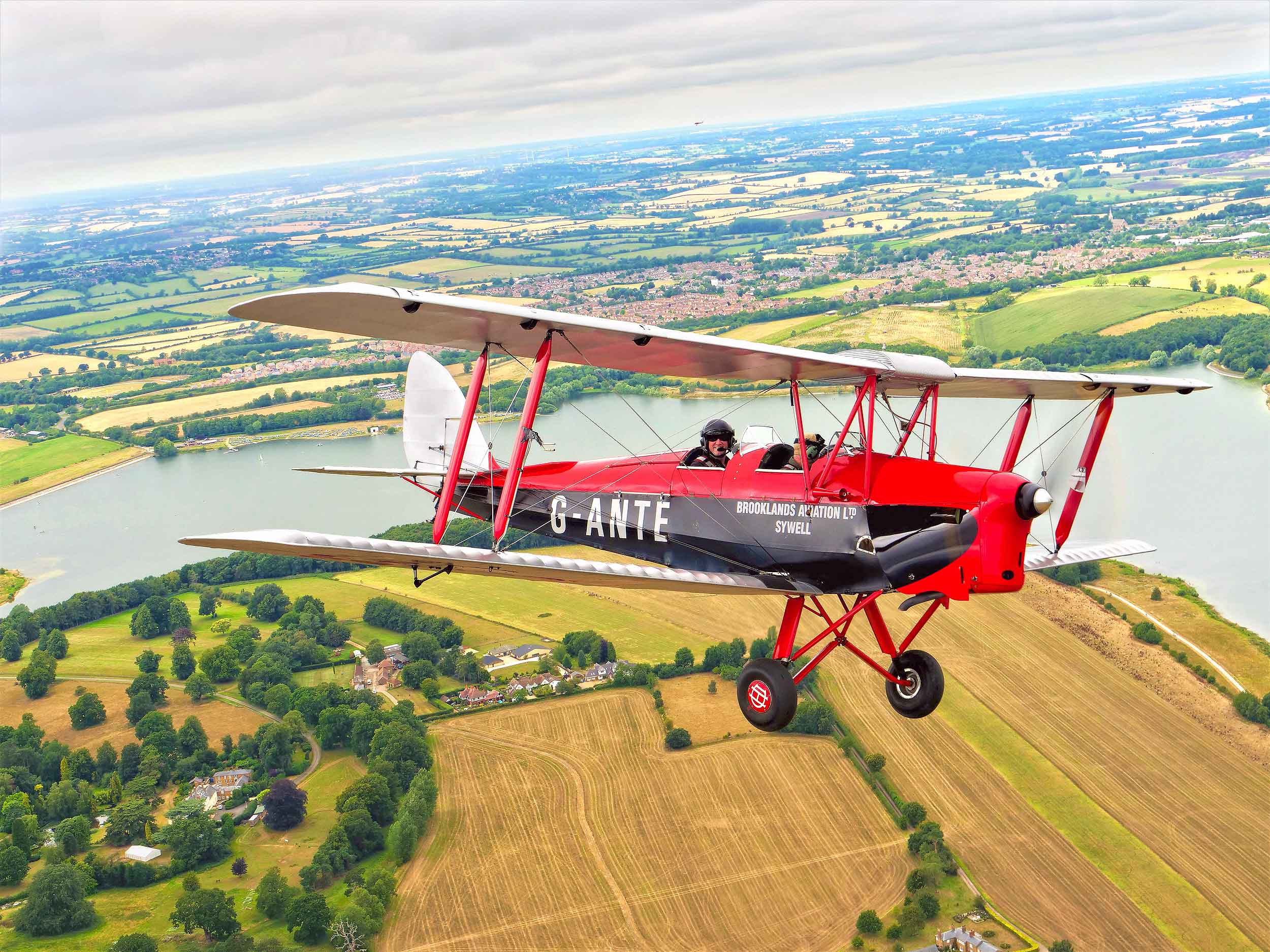 Thomas Castle Aviation Heritage Scholarship de Havilland DH.82a Tiger Moth II G-ANTE over Pitsford Water near Sywell with Richard Grace