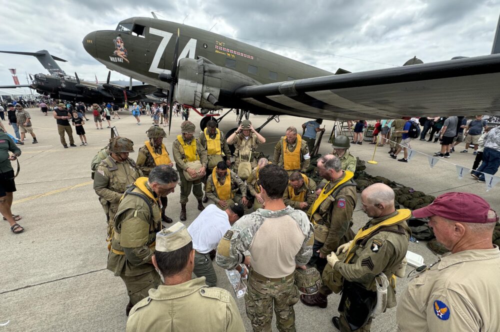 Paratrooper re-enactors prepare to jump out of a C-47 during the airshow to commemorate the 80th anniversary of D-Day