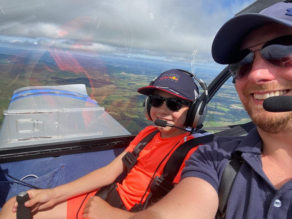 Tim Marley flying with his son.