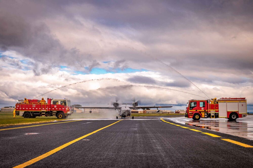 Fire trucks forming a water arch