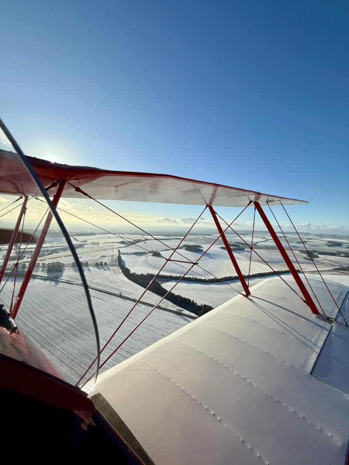 Flying over a snowy landscape.