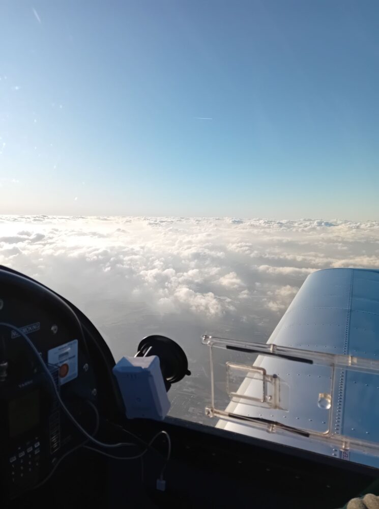 View of clouds below from EV97 cockpit.