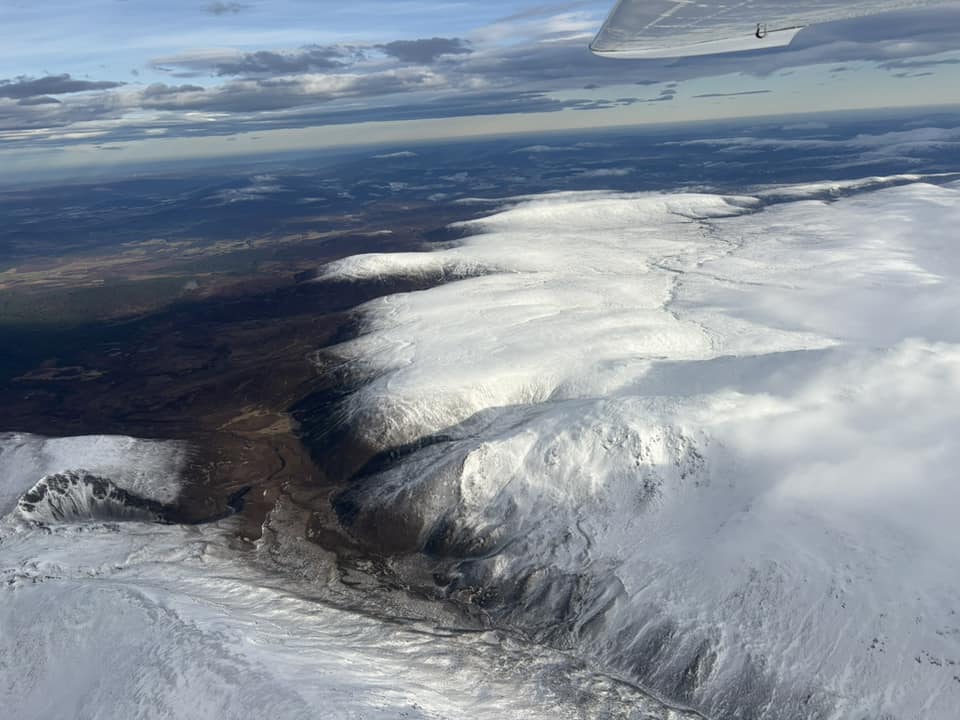 Aerial view of snow-covered highlands of Scotland.