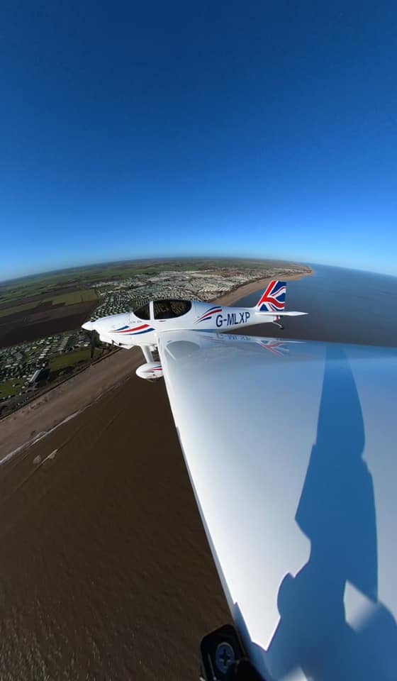 Aerial view of light aircraft over the coast.