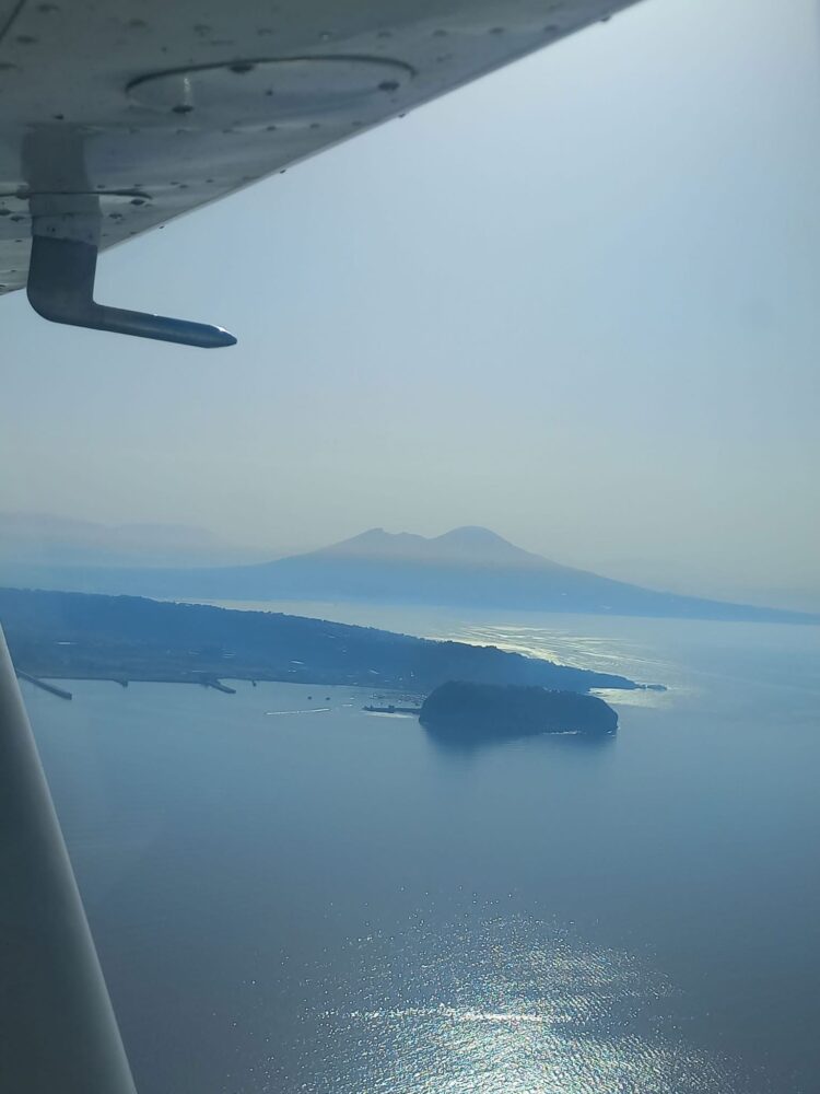 Flying across the bay of Naples, with Vesuvius in the background.