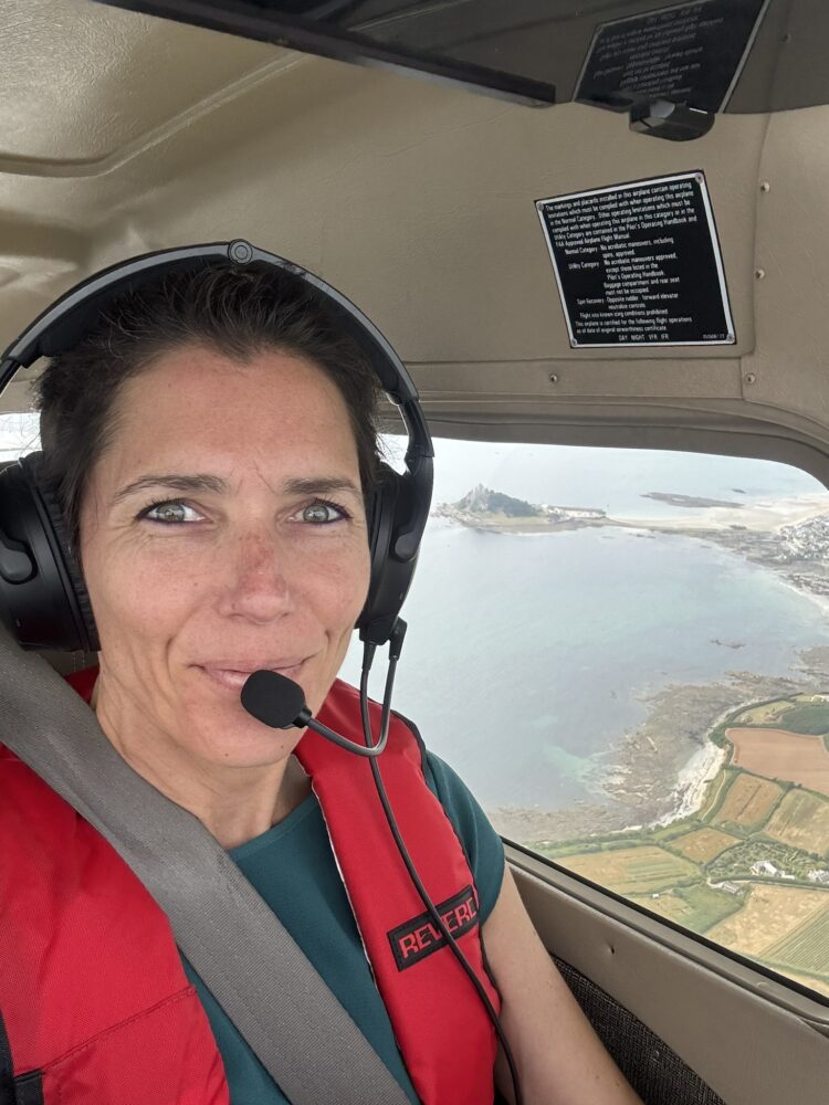 Karen enroute during her Dawn to Dusk Challenge with Cornwall's St Michael's Mount out of the window