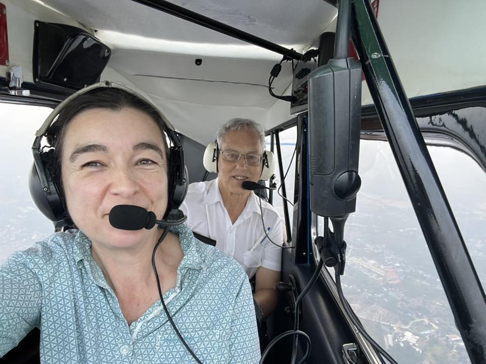 Two people in a light aircraft.