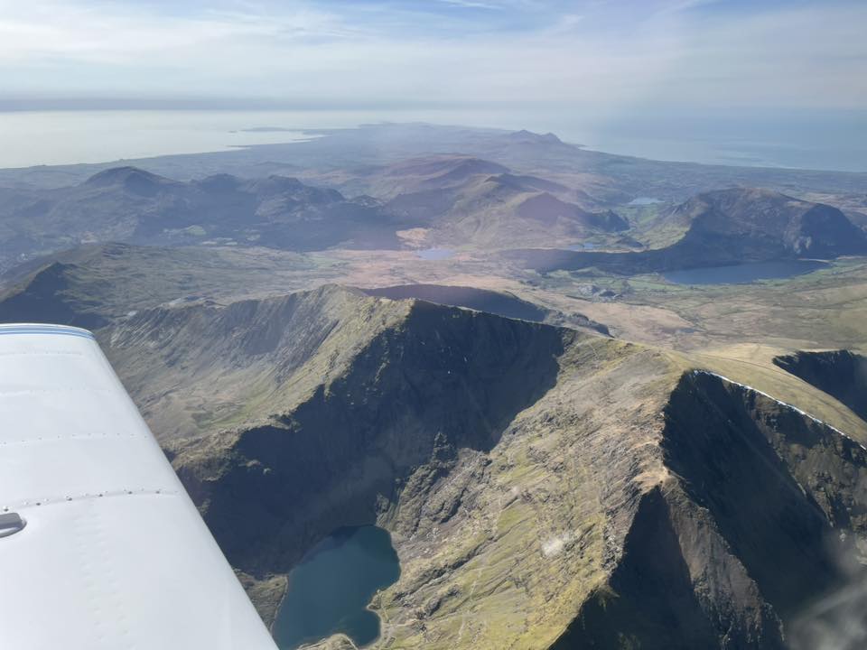 Light aircraft wing and mountains.