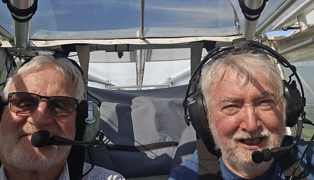 Two men in a light aircraft