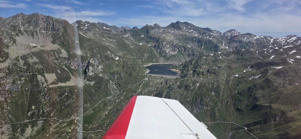 Light aircraft wing over the Alps.